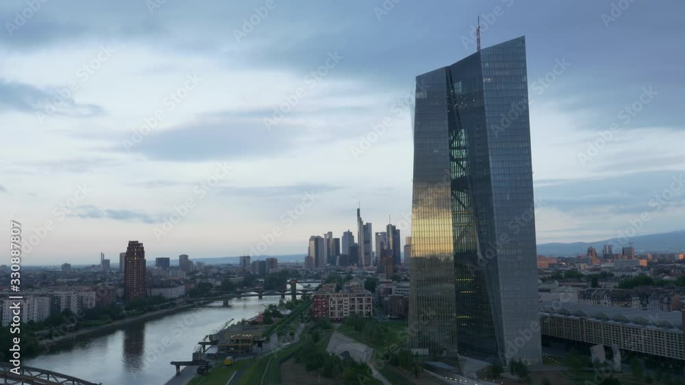 Moody European Central Bank ECB tower in Frankfurt am Main Germany from a drone at sunrise, little reflection 4K