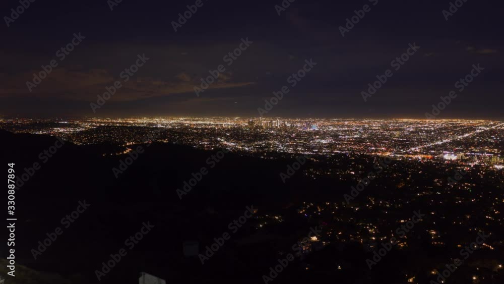 AERIAL HYPER LAPSE: Over Hollywood Signe at Night in Los Angeles, California at Night wirh Glowing Cityscape Time Lapse [4K]