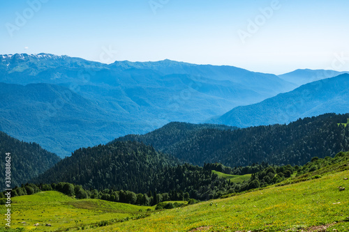 View over the Green Valley  surrounded by high mountains on a clear summer day