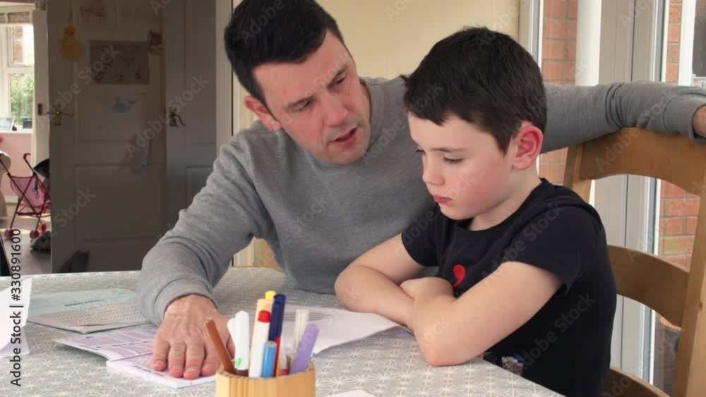 Young Boy Being Homeschooled By His Parent. COVID-19 Schools Closed Concept Young Boy Being Homeschooled By His Parent. COVID-19 Schools Closed Concept