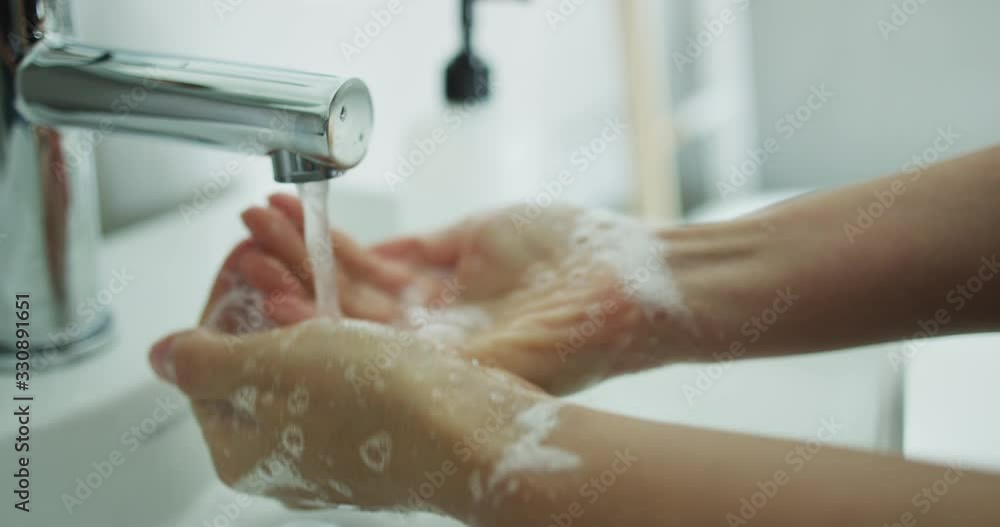 Washing hands man rinsing soap with running water at sink, Coronavirus prevention hand hygiene. Corona Virus pandemic protection by cleaning hands frequently. Washing hands man rinsing soap with running water at sink, Coronavirus prevention hand hygiene. Corona Virus pandemic protection by cleaning hands frequently.