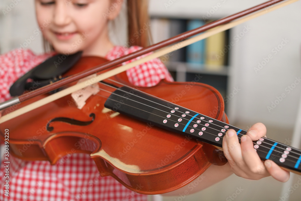 Little girl playing violin at music school Little girl playing violin at music school