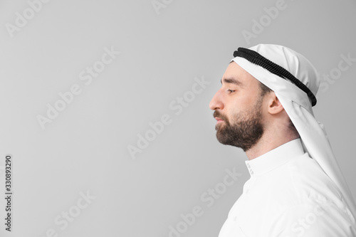 Handsome Arab man on grey background