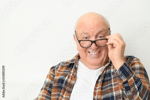 Portrait of elderly man at home