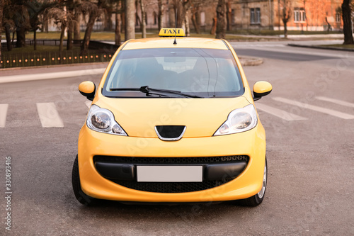 Modern taxi car on city road © Pixel-Shot