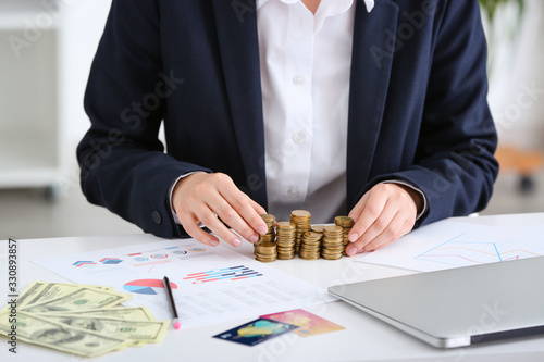 Bank manager with coins on ...