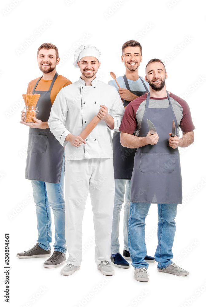 Fototapeta premium Male chef with participants of cooking classes on white background