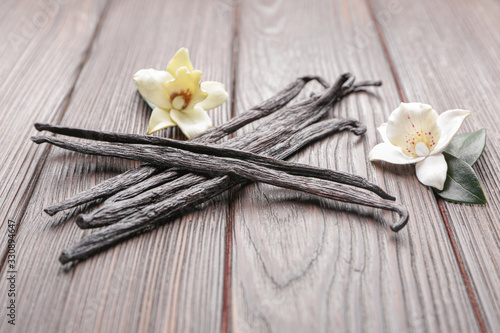 Aromatic vanilla sticks on wooden background