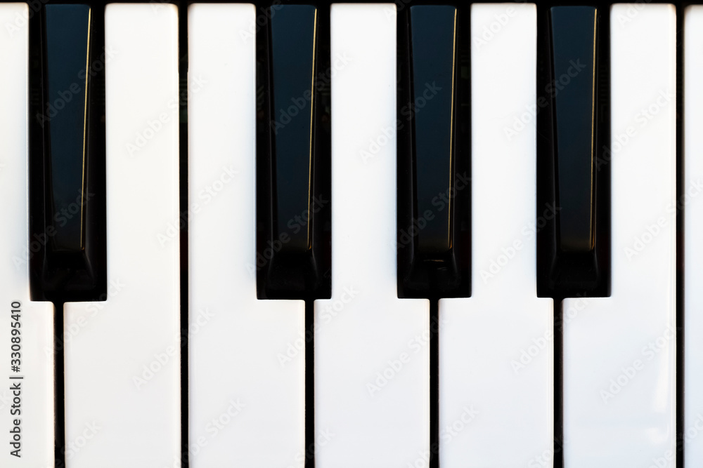 Fototapeta premium Black and white piano keys close up.