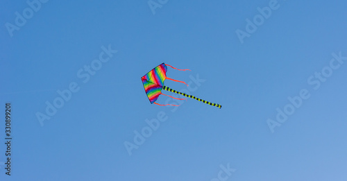 Colorful kite with blue sky background.