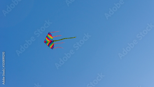 Colorful kite with blue sky background.
