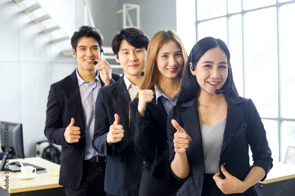 Obraz premium Asia Group of call center workers or Confident business team with headset in office.