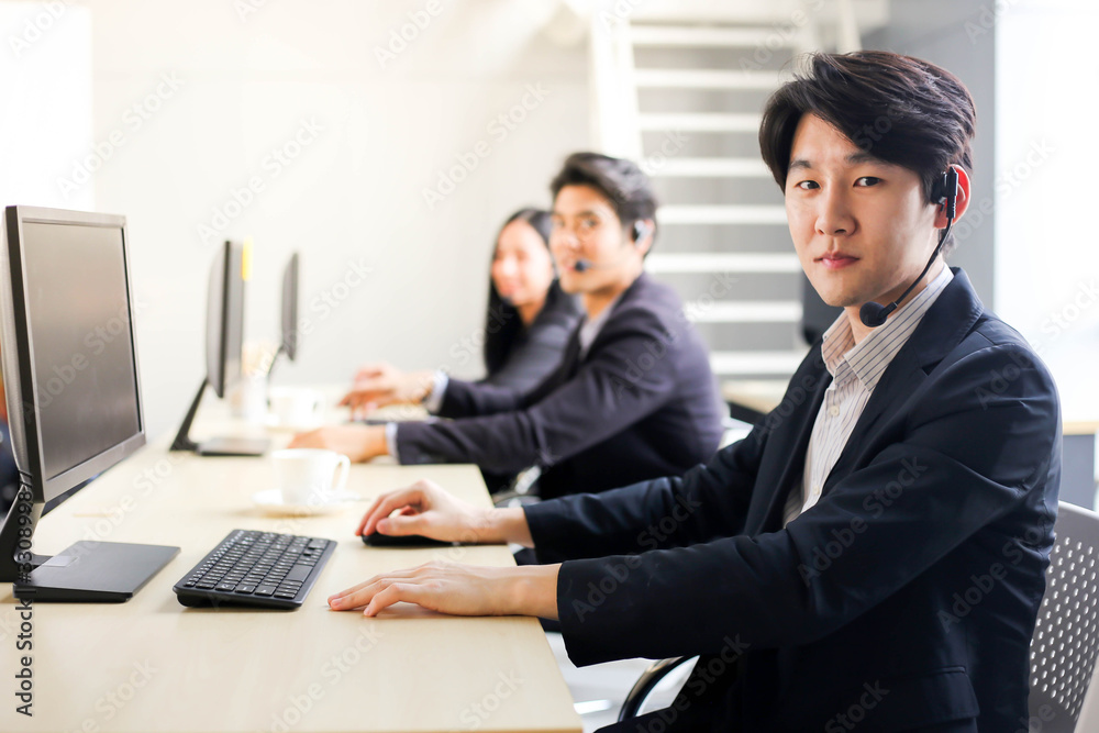 Asia Group of call center workers or Confident business team with headset in office. Asia Group of call center workers or Confident business team with headset in office.
