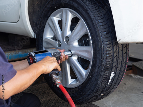 Close up mechanic man hand use tire changing tools