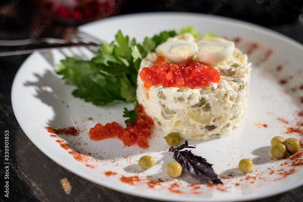 Olivier salad with red caviar from green peas of pickles, restaurant serving, bar serving Olivier salad with red caviar from green peas of pickles, restaurant serving, bar serving