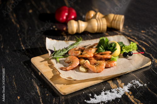 large shrimp on a wooden plank, king prawns, boiled shrimps, seafood photo