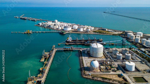 Fotografie Aerial view tank farm terminal for bulk petroleum and gasoline storage, Crude oil storage fuel petrochemical terminal, Business global oversea commercial distribution petroleum product worldwide