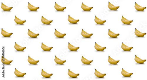 Minimalistic Symmetrical pattern of a bunch of banana on a white background. Abstract summer colorful fruit background.