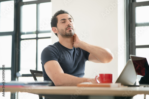 Portrait of freelancer or office man having symptoms neck ache from office syncdrom, stressful of work while working at the office, the concept of pressure from work, working lifestyle, stressful work