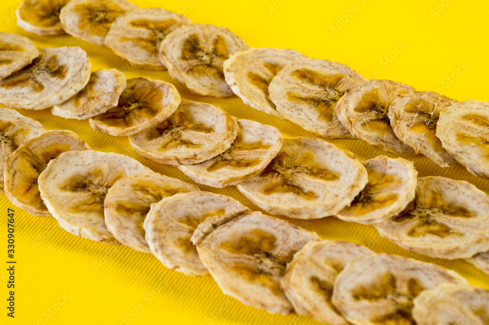 Dried banana chips, sliced in thin circles. Background for healthy and natural nutrition. Dried banana chips, sliced in thin circles. Background for healthy and natural nutrition.