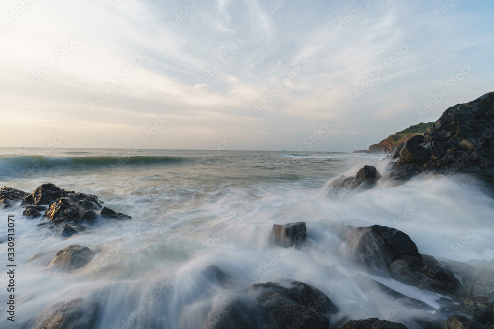Seascape and ocean waves with unique basalt geology, natural landscapes at Zhangzhou Volcanic park at Sunrise, Fujian, China Seascape and ocean waves with unique basalt geology, natural landscapes at Zhangzhou Volcanic park at Sunrise, Fujian, China