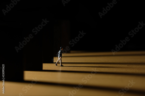 Wallpaper Mural Business conceptual photo – miniature of businessman coming out from office building at dawn – coming home late concept Torontodigital.ca
