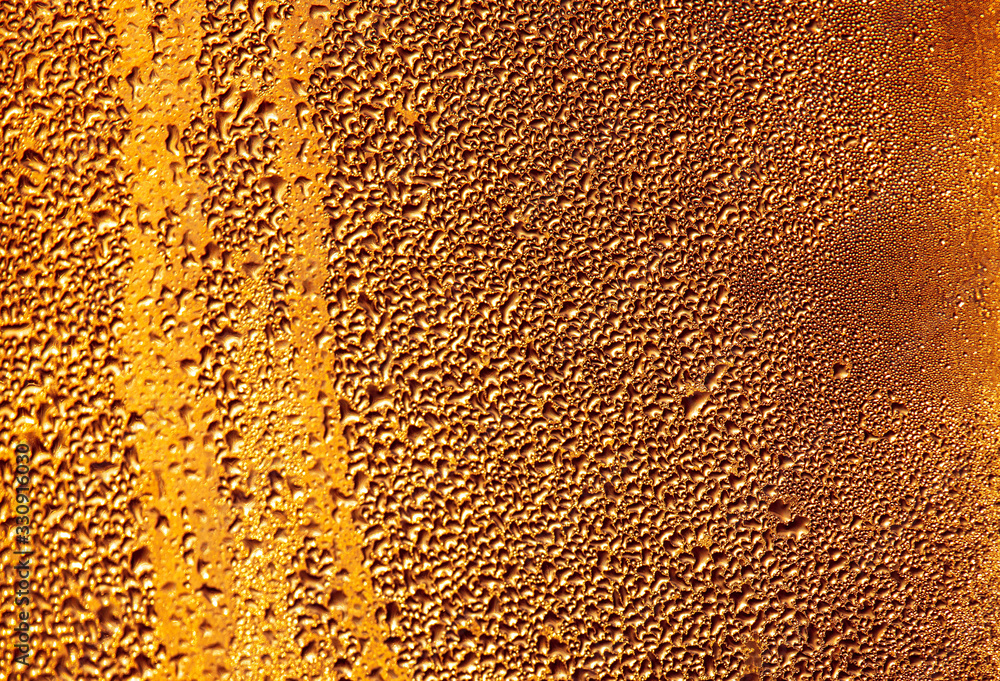 Drops of water on a glass in the golden rays of the sun. Drops of water on a glass in the golden rays of the sun.
