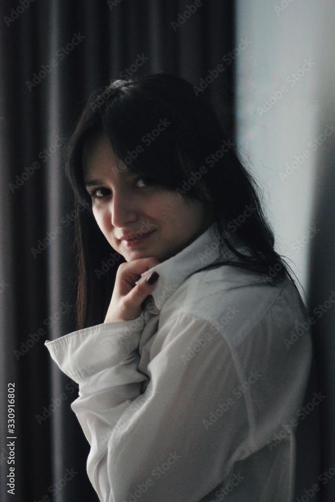 Attractive caucasian brunette girl at home, emotional portrait