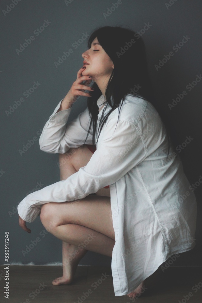 Attractive caucasian brunette girl at home, emotional portrait