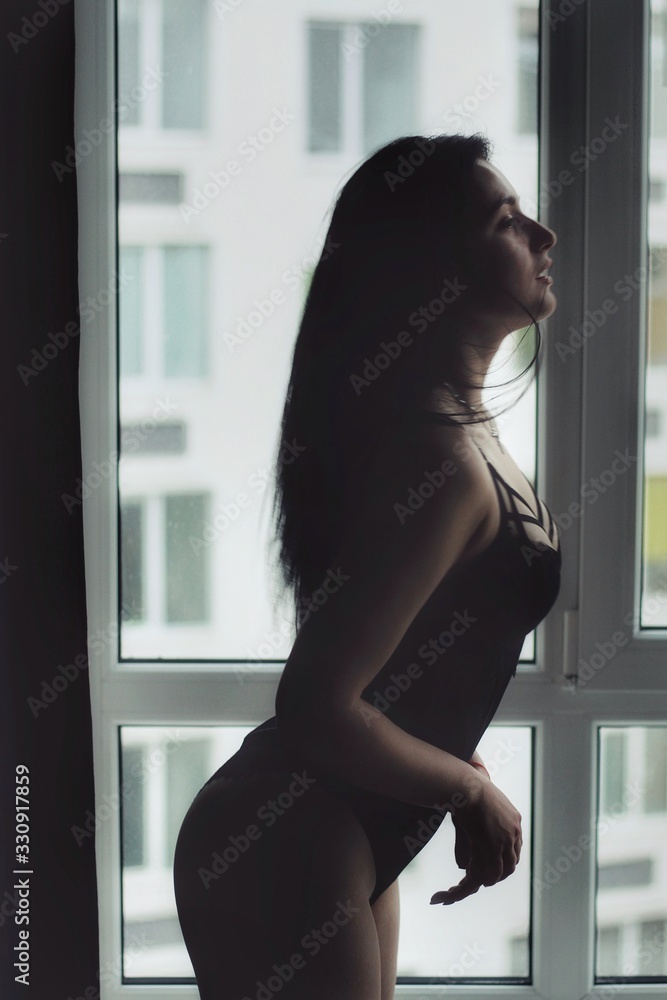 Attractive caucasian brunette girl at home, emotional portrait