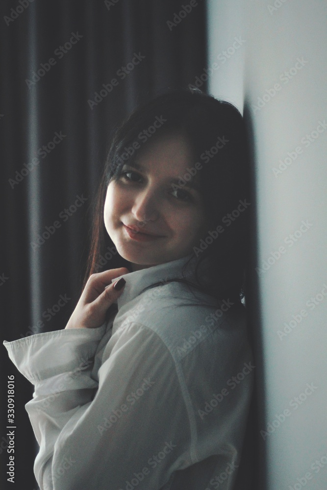 Attractive caucasian brunette girl at home, emotional portrait