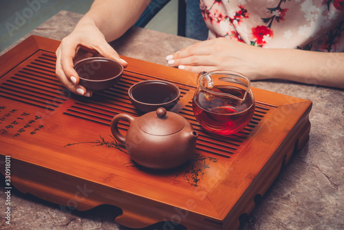 Chinese tea ceremony. Woman drinking tea