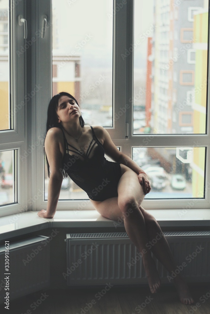 Attractive caucasian brunette girl at home, emotional portrait