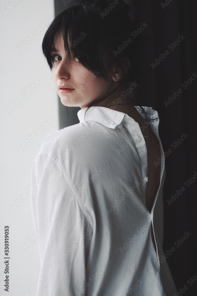 Attractive caucasian brunette girl at home, emotional portrait