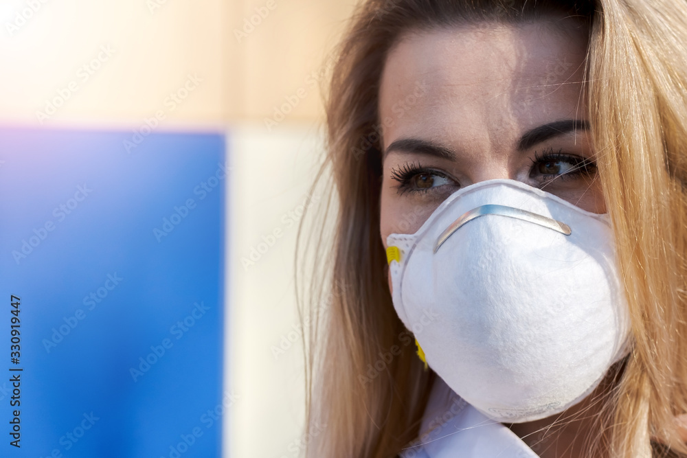 Young Beautiful Blonde Caucasian Woman Standing in a Protective Mask Young Beautiful Blonde Caucasian Woman Standing in a Protective Mask
