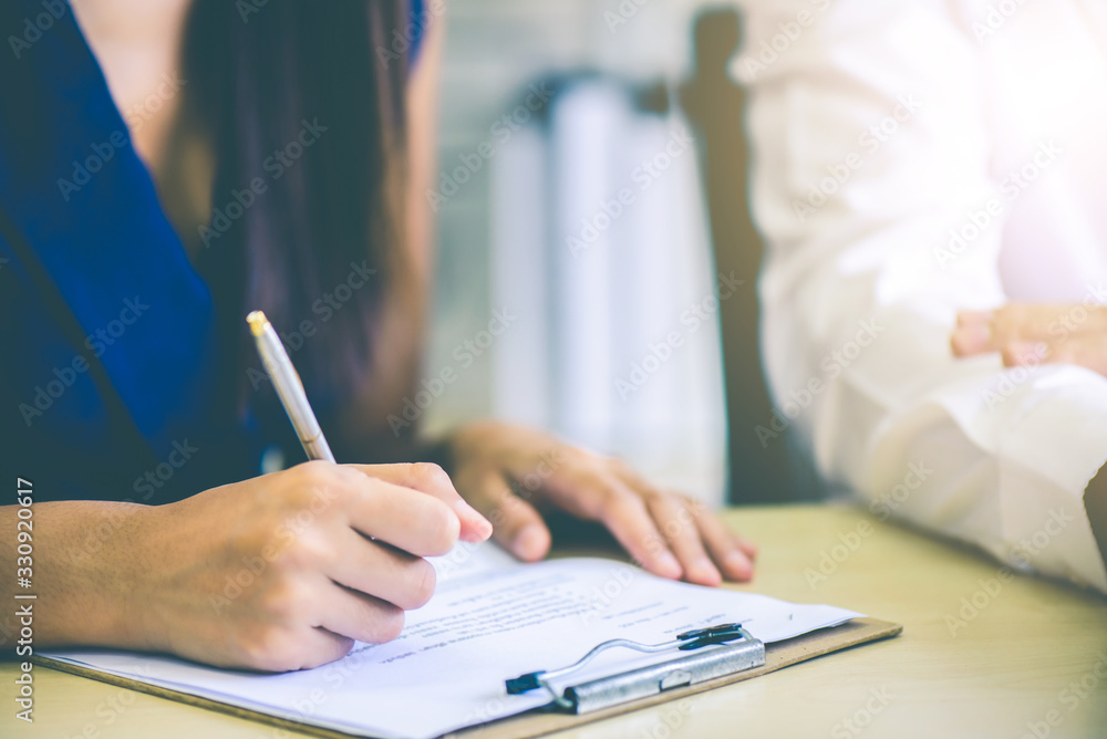 Hand of business woman or secretary take note on paperwork while business meeting at office, business financial presentation conference concept Hand of business woman or secretary take note on paperwork while business meeting at office, business financial presentation conference concept