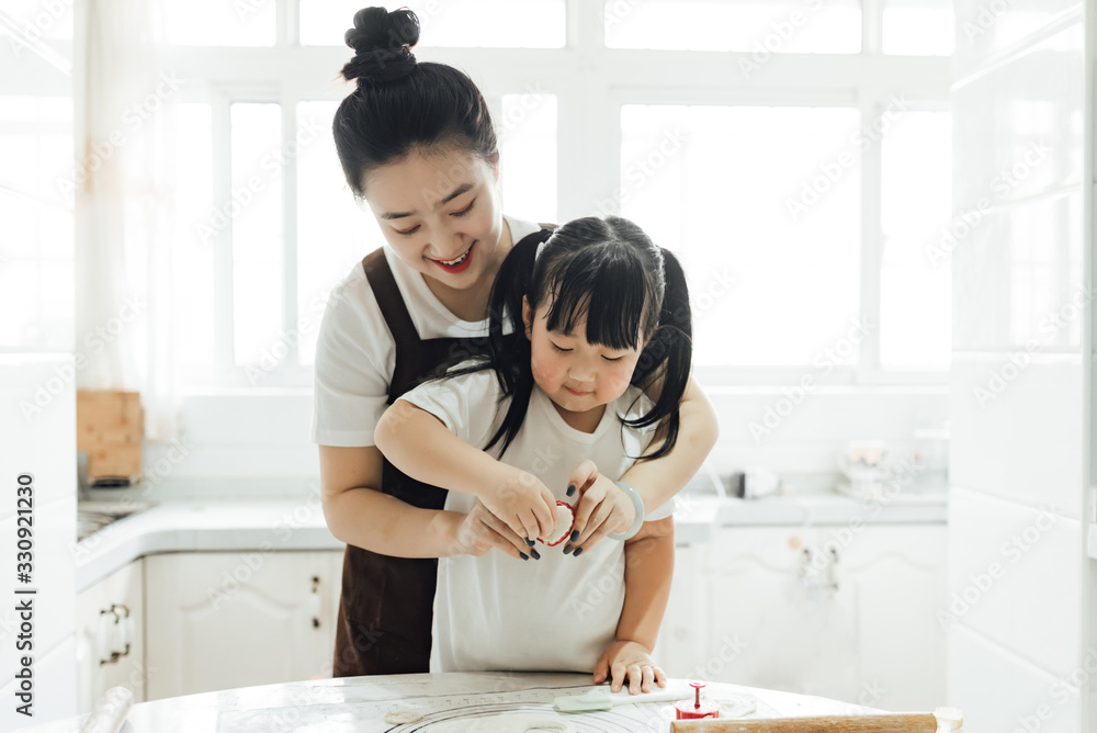 The family is baking bread in the kitchen The family is baking bread in the kitchen