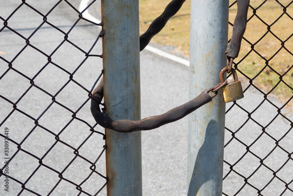 The door locked with Metal chain and padlock The door locked with Metal chain and padlock