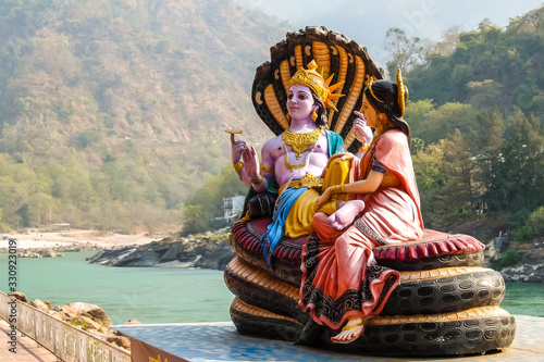 Rishikesh, India. Beautiful statues of Lord Vishnu and Lakshmi at the Ganga riverbank in Rishikesh. photo