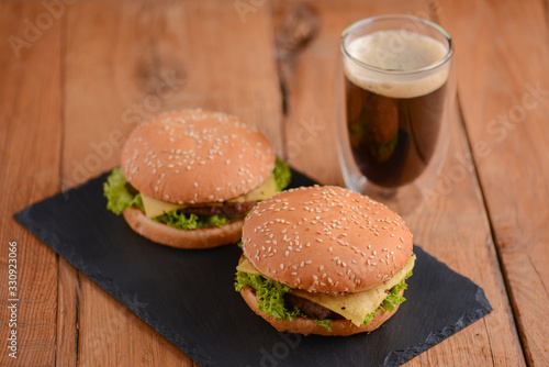Two hamburgers, cola on the rustic wooden table. Fast food, junk food concept. Food photography concept.