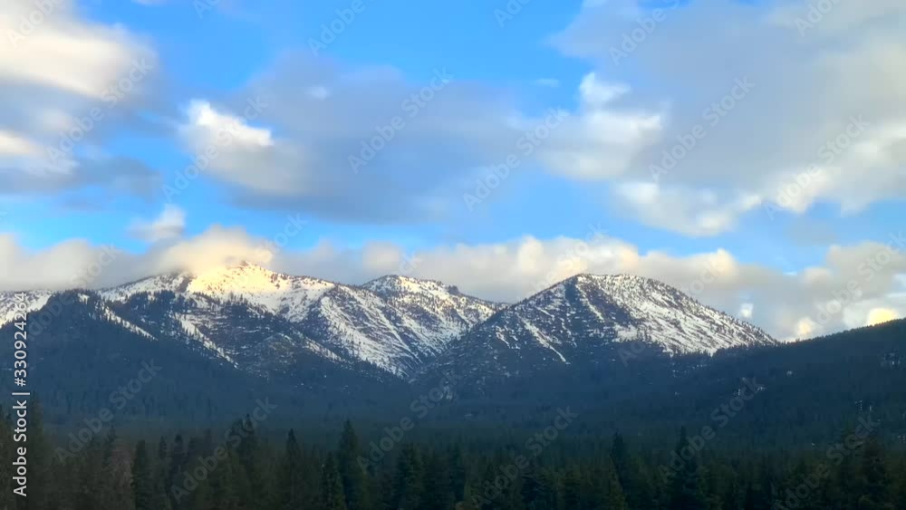 Snow capped mountains with clouds moving in and out of the sky. Winter time lapse video of the Sierra Nevada Mountains in Lake Tahoe, Nevada (USA). HD. Snow capped mountains with clouds moving in and out of the sky. Winter time lapse video of the Sierra Nevada Mountains in Lake Tahoe, Nevada (USA). HD.