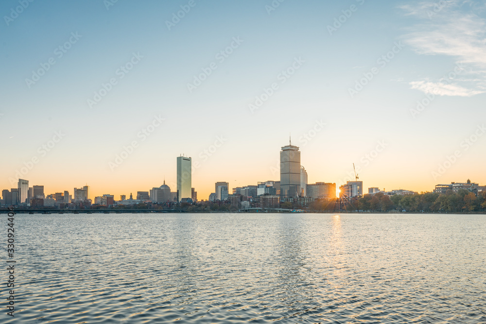 Boston cityscape with river in front at sunrise