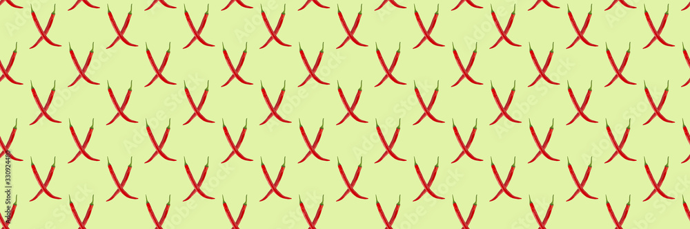 Seamless pattern of red hot chilli peppers on a green background. Minimal concept, isometric food texture. Seamless pattern of red hot chilli peppers on a green background. Minimal concept, isometric food texture.