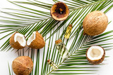 Coconut background with oil on white background top-down