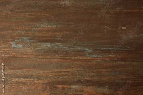 The texture of the copper background is covered with a patina