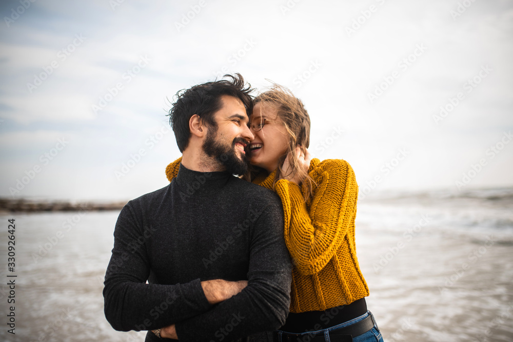 Emotional guy and girl on the seashore in cloudy weather close up