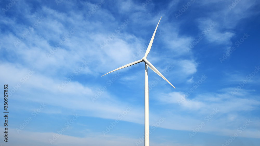 Wind turbine against cloudy blue sky background Wind turbine against cloudy blue sky background