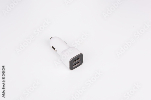 USB car adapter, phone charger on white background