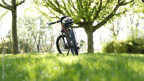 A bike on the park green grass in sunny spring