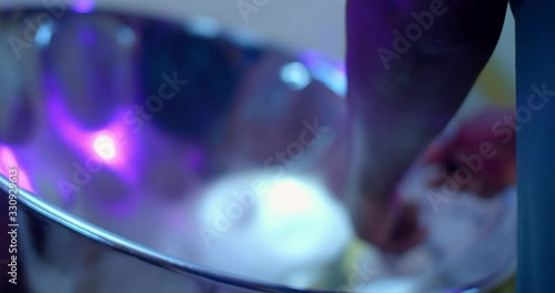 Low angle of hands playing a Steel Pan/ Steel Drum instrument photo